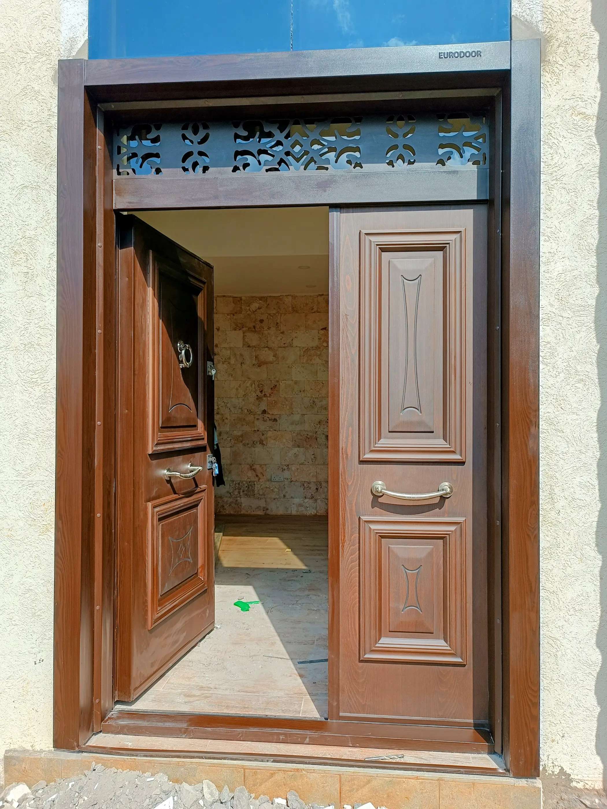 large natural wood coated external door installed in a luxury mansion